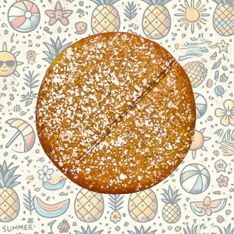 Power cookie pineapple with powdered sugar on a summer-themed background with pineapples, flowers, and suns.
